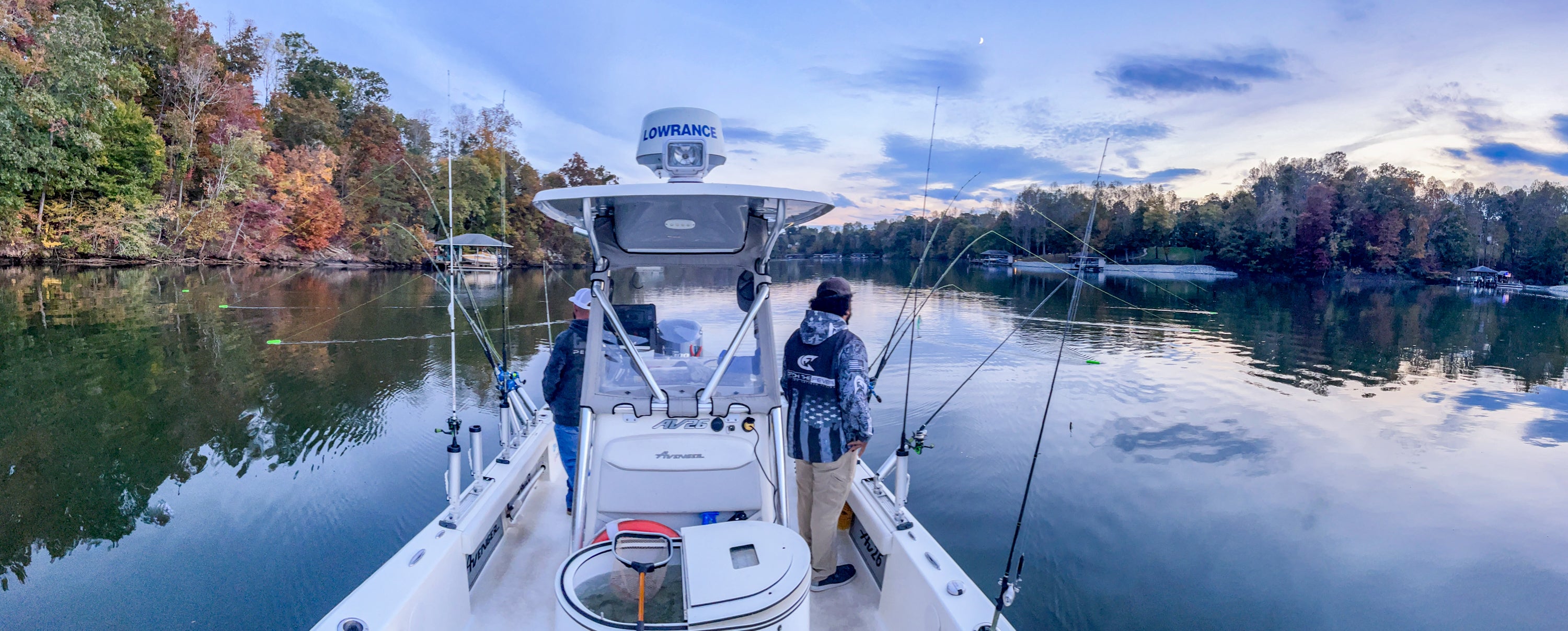 Two anglers fishing on a boat using Alphaboardz planer boards on both starboard and port sides.